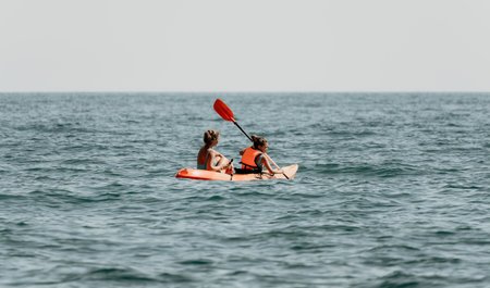 Two People Kayaking on a Calm Seaの写真素材