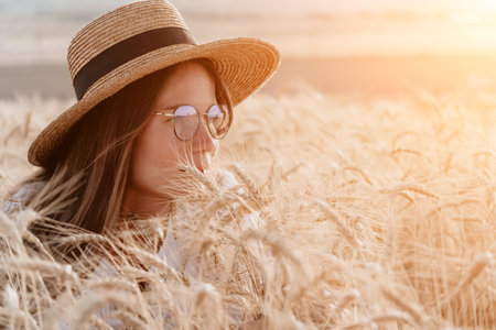 Woman Wheat Field Sunset: Summer portrait, serene nature, golden hour ambiance.の写真素材