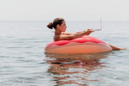 Woman Laptop Float Relaxing Ocean Beach Summer Vacationの写真素材