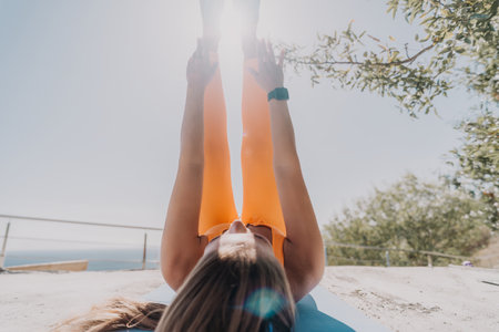 Woman Exercising Outdoors on a Sunny Dayの写真素材