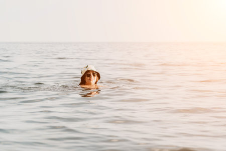 Woman Swimming Ocean Water Hatの写真素材