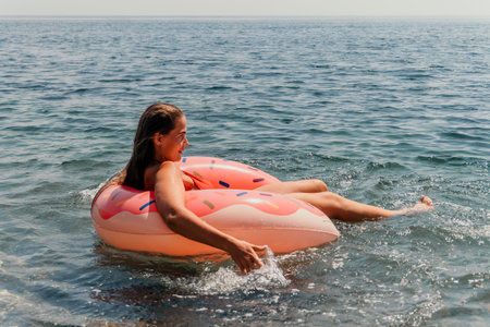 Woman Inflatable Float Sea Relaxing in Calm Waterの写真素材