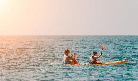 Two Women Enjoying a Kayak Trip on a Clear Dayの写真素材