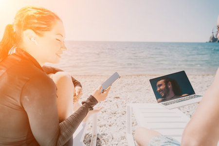 Woman Beach Laptop Video Call Relaxing on Beachの写真素材