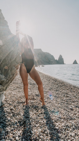 Silhouette of a Woman on a Pebble Beachの写真素材