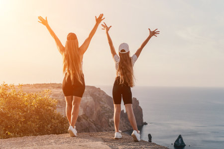 Two Women Celebrating on a Cliffsideの写真素材