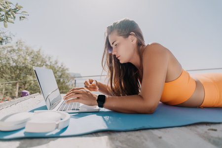 Woman Working on Laptop Outdoorsの写真素材