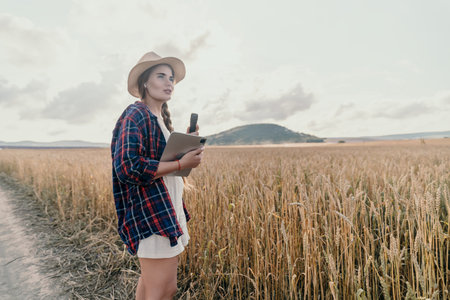 Young Woman in a Wheat Field with a Tablet
