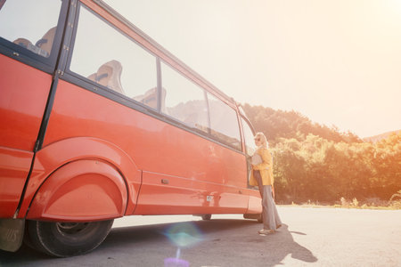 Bus, Mountains, Travel: People getting off a red bus in a scenic mountainous area for a travel...