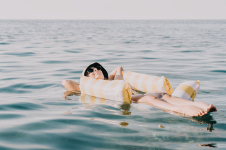 Woman, Inflatable, Sea - A woman floats on an inflatable raft in the sea.