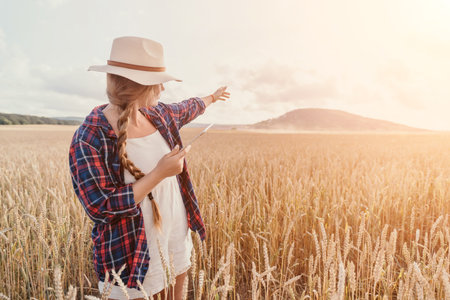 Woman wheat field. Agronomist, Woman farmer check golden ripe barley spikes in cultivated field....
