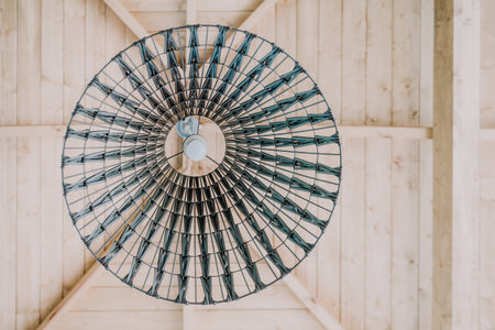 Circular Woven Lamp Shade in a Wooden Roomの写真素材