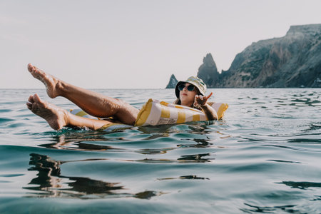 Woman, Inflatable Raft, Sea - Relaxing on a yellow inflatable raft in the sea.