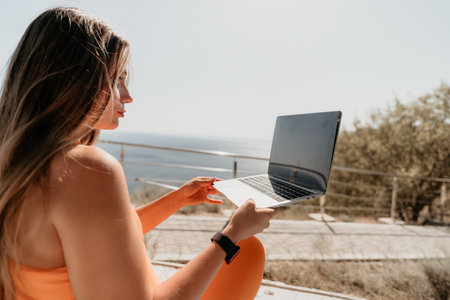 Young Woman Using Laptop Outdoors