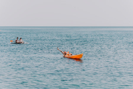 Kayaking Ocean Water Two people kayaking on the ocean on a calm day.
