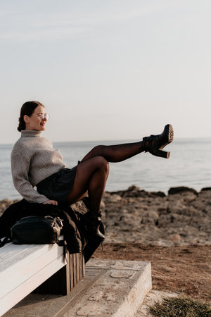 Woman sitting coast young woman enjoys a relaxing moment on the rocky coast