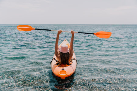 Kayaking Woman Ocean Paddle Recreation - A woman kayaks in the ocean on a sunny day.の写真素材