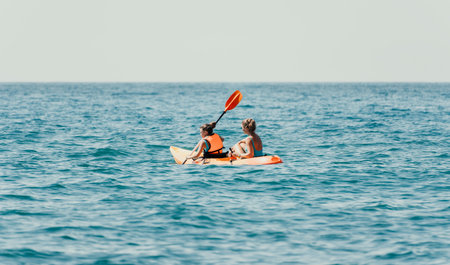 Two Women Kayaking on a Calm Oceanの写真素材