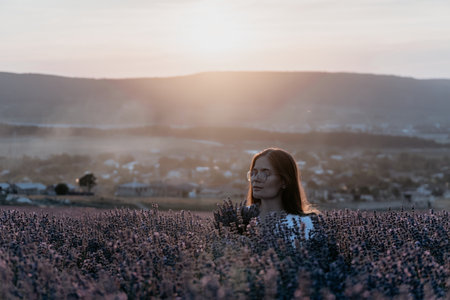 Woman in Lavender Field at Sunsetの写真素材
