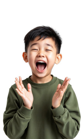 Excited Kid Pose Young Asian boy with hands up in excitement, wide smile, green long-sleeved shirt, soft front lightingの素材