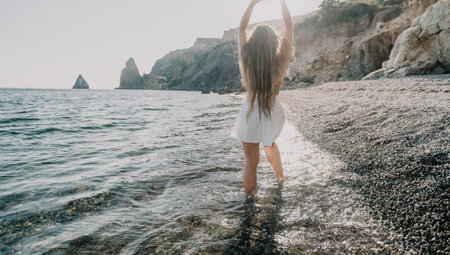 Woman in White Dress Walking on a Beachの写真素材