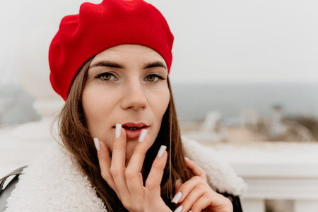 Woman, beret, portrait, stylish woman in red beret with a thoughtful expression outdoors.の写真素材