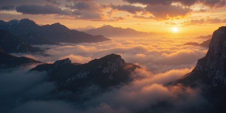 Golden Hour Mist Over a Mountain Ridge A breathtaking, atmospheric landscape with rolling mist enveloping mountain peaks, bathedの素材