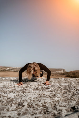 Woman Doing Push-Ups on a Rocky Cliff