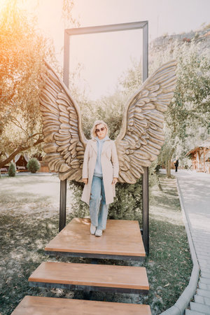 Woman Posing with Giant Angel Wings