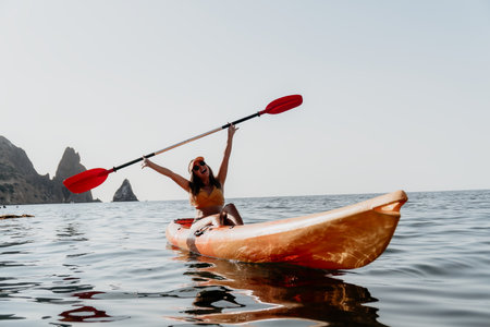 Kayaking Woman Ocean Paddle - Happy woman kayaking in the ocean on a sunny day.の写真素材