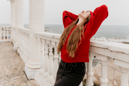 Woman Relaxing Balcony Seaside Serenityの写真素材