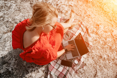 Woman Working on Laptop Outdoorsの写真素材