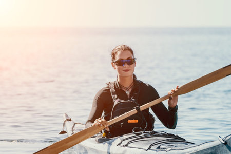 Kayaking, Water, Paddle - Woman in Sunglasses Kayaking on a Calm Water Body on a Sunny Dayの写真素材