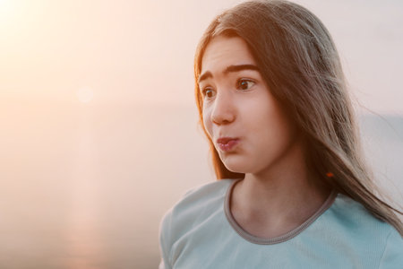 A Girl Gazing at the Sunsetの写真素材