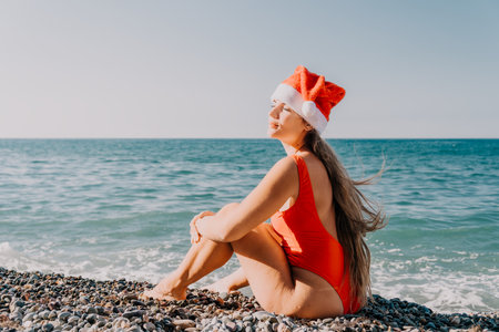 Woman in Santa Hat Relaxing on a Beachの写真素材