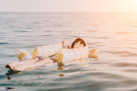 Woman, Inflatable, Sea - A woman floats on an inflatable raft in the sea.