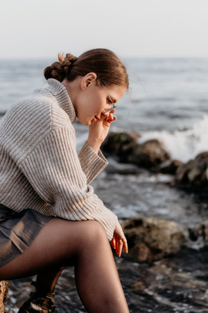 Woman Oceanside Contemplation: Coastal pensive portrait, autumn, emotional reflection.の写真素材