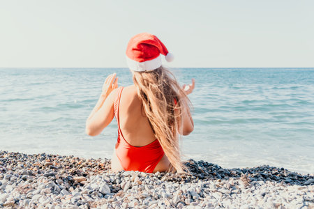 Woman in a Santa Hat on a Beachの写真素材