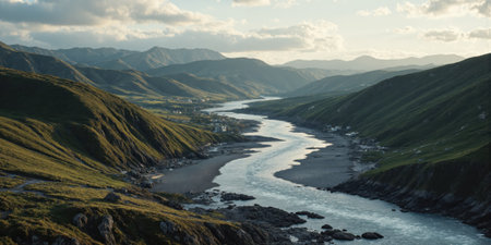 River Mountains Landscape: Morning Sunlight shines on river flowing through valley with hills, idyllic scenery.の素材