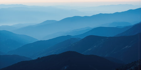 Atmospheric Mountain Layers Misty mountain ridges create a layered landscape that recedes into the distance, each range becoming progressively lighterの素材