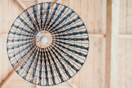 Wicker Lamp Shade Against a Wooden Ceilingの写真素材