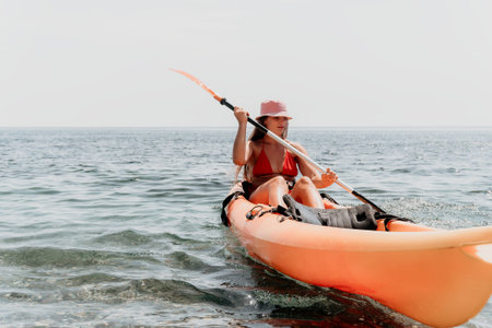 Kayaking Woman Water Paddle - Woman paddling kayak in ocean water on calm day.の写真素材