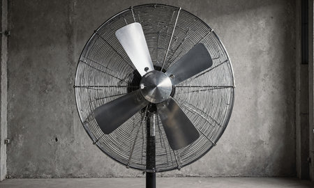 Wind Machine Stillness. A powerful, industrial-sized wind machine or fan stands idle in the center of a studio. Its largeの素材