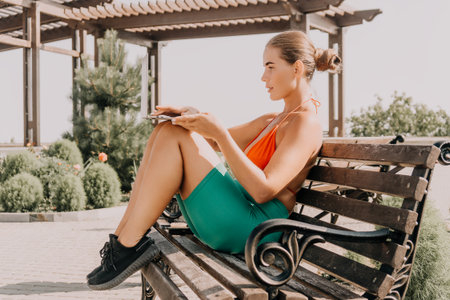 Woman Bench Park Relaxing Summer Outfit - Woman sitting on a park bench, wearing a summer outfit, and relaxing.の写真素材