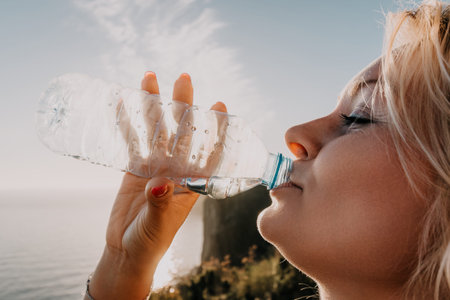 Woman Drinking Water Bottle Ocean Cliffside Landscape