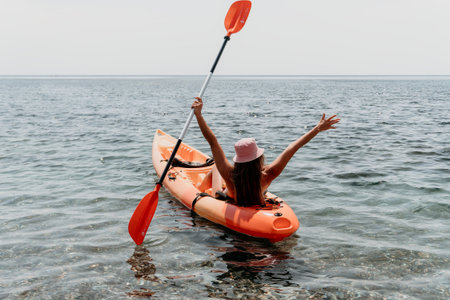 Kayaking, Water Sports, Woman enjoying a kayak trip on a calm seaの写真素材