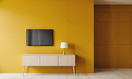 Yellow Bold Wall - Mustard-painted wall with mounted flat-screen above slim pale cabinet styled with lamp; frontal head-on shot, crispの素材