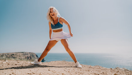 Blond Woman in White Skirt on a Cliffsideの写真素材
