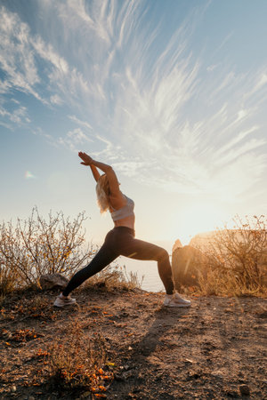 Yoga Woman Mountain Sunset Nature - A woman performs yoga in warrior pose on a mountaintop with a...