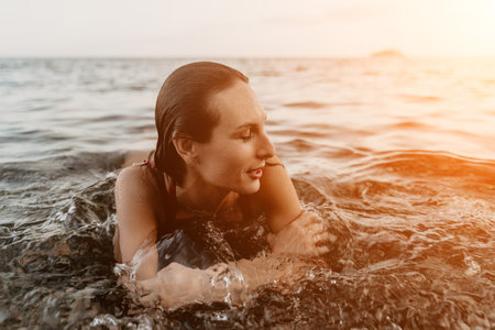 Woman, ocean, sunset: serene lady enjoying tranquil water at golden hour with copy space.